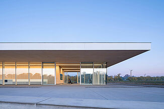 Neil Campbell Rowing Centre - Sideview of Facility Side view of the Neil Campbell Rowing Centre facility, showcasing the innovative glass walls and design.