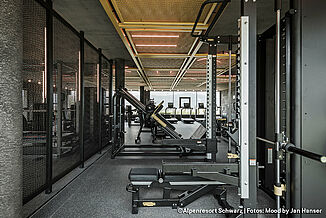 Different fitness equipment in a gym with dark-coloured REGUPOL flooring