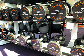 Weight Rack in Clemson Weight Room Clemson dumbbells on a rack in the Clemson weight lifting facility.
