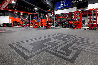 Texas Tech Volleyball - Inlaid Logos View of the Texas Tech Volleyball weight room flooring, featuring REGUPOL aktivpro roll flooring and custom inlaid rubber logos.