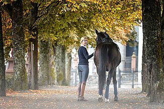 Dressage rider Nathalie zu Sayn-Wittgenstein leads her horse into the stable