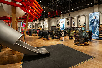 REGUPOL safety flooring under a slide in a shop Safety flooring under a slide in a shop