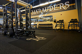 Millersville University Performance Center - Weight Rack Area View of the weight rack in the Millersville University featuring REGUPOL aktivpro roll and crash flooring throughout the facility.