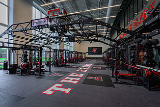 Texas Tech Football - Full View Full view of Texas Tech football weight room, showcasing the weight training racks and free weight area.
