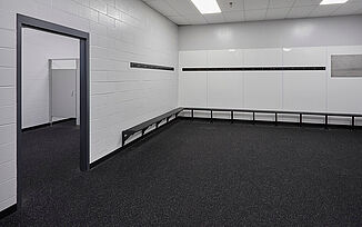 Thayer Sports Center Locker Room Thayer Sports Center's empty locker room with black bench, white lockers and REGUPOL aktiv rolled rubber flooring.