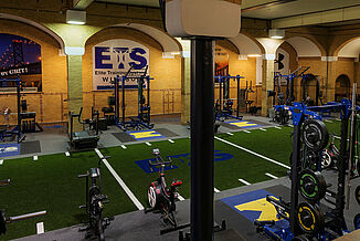 Elite Training Systems - Aerial View with REGUPOL flooring Aerial view of the Elite Training Systems facility in the Honourable W.C. Kennedy Collegiate building. The facility features a turf area and REGUPOL aktivpro roll flooring and REGUPOL crash inlaid platforms for optimal durability and versatility.