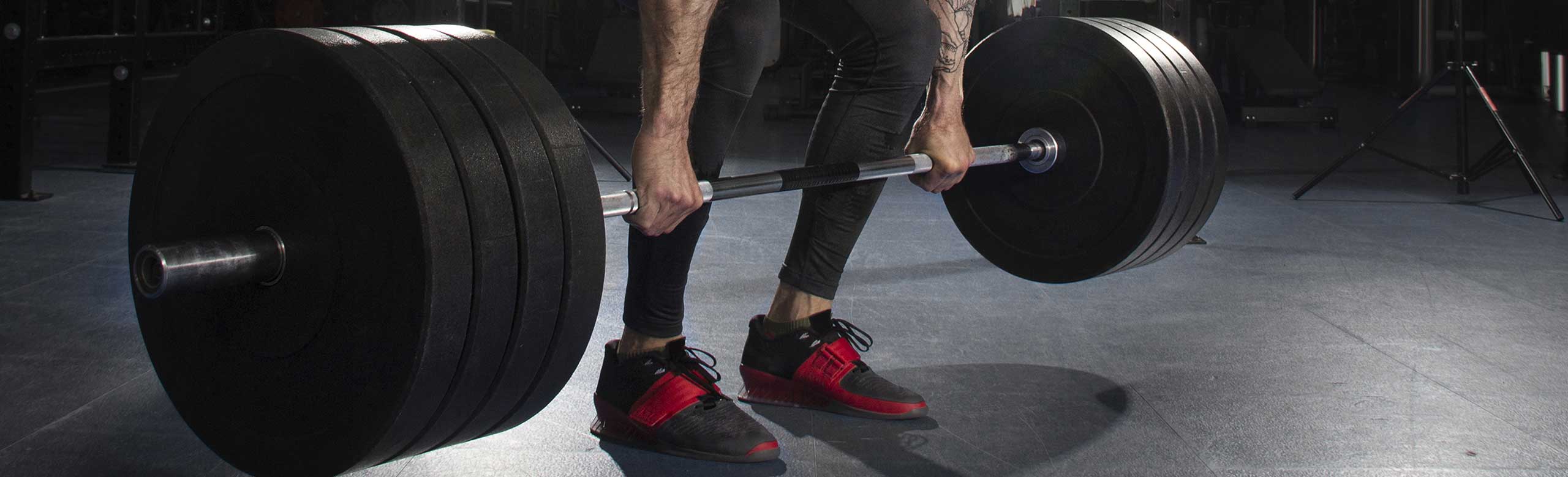 A man lifts a heavy barbell during Crossfit training on REGUPOL flooring A man lifts a heavy barbell during crossfit training