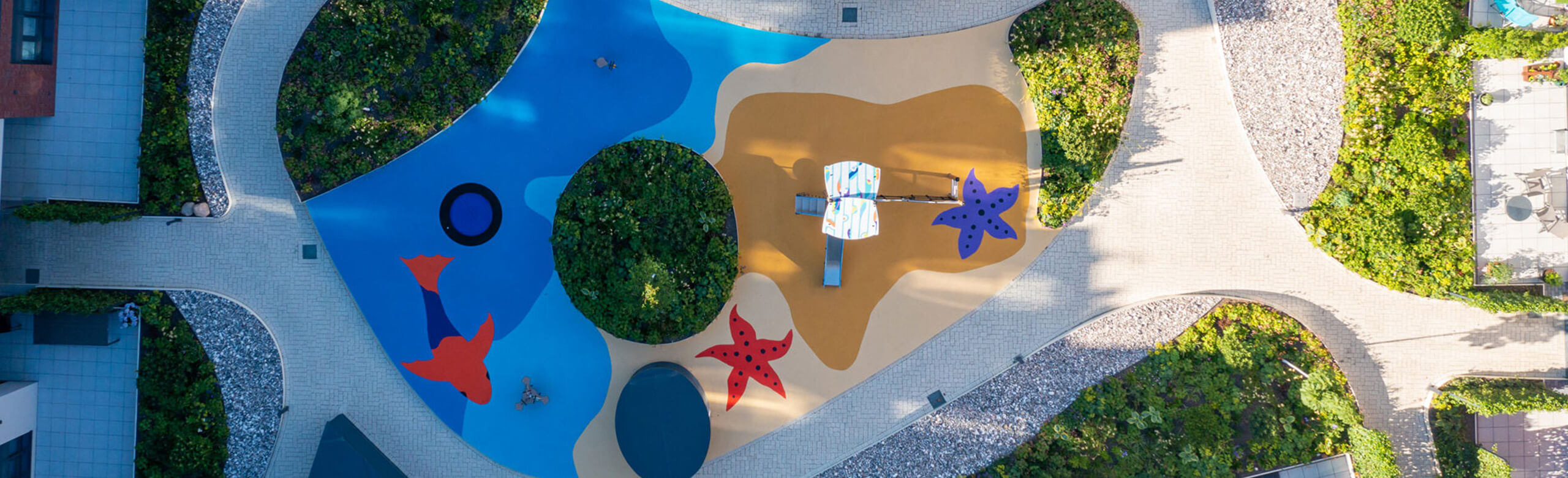 Seamless safety flooring from REGUPOL. Playground with a seamless safety flooring in beach design (fish, starfish, sand, water) from REGUPOL