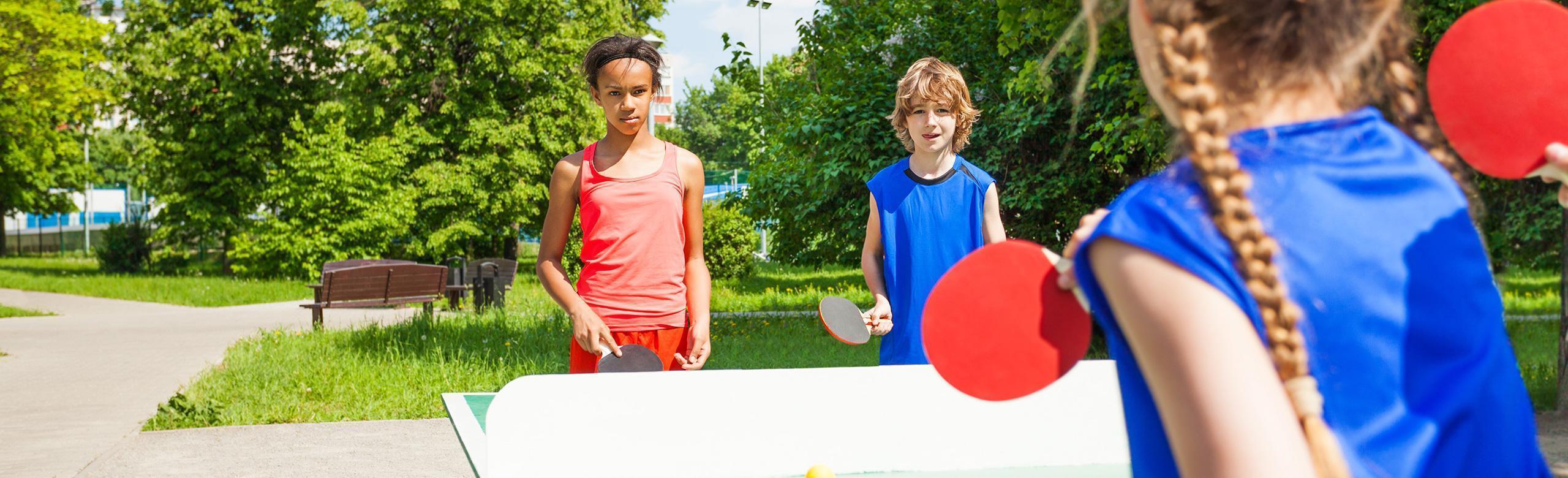 Kids play table tennis on a synthetic flooring from REGUPOL.