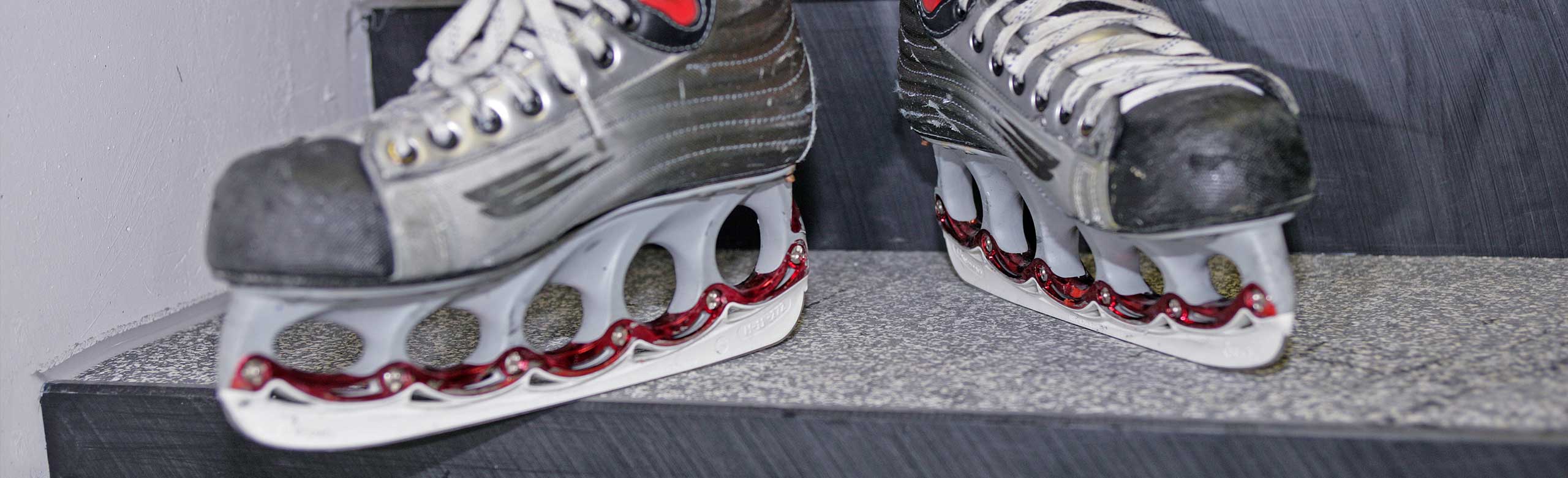 Skates on a dark grey flooring Skates on a dark grey flooring
