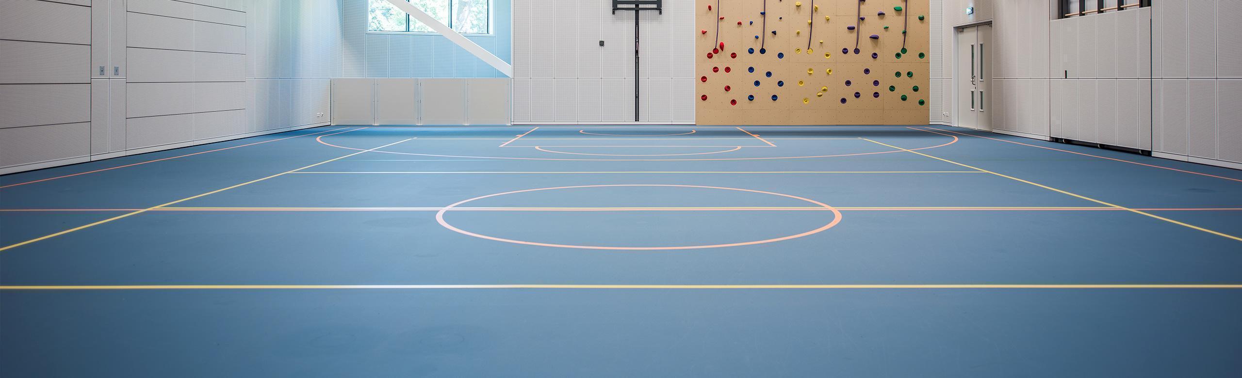 Sports hall with a blue sportshall flooring and white lining