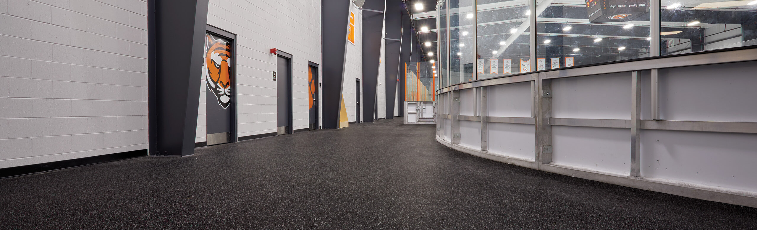 Thayer Sports Center Hockey Rink- Outer Walkway An outer view of the walk way around Thayer Sports Center hockey rink with multiple doorways to locker rooms.